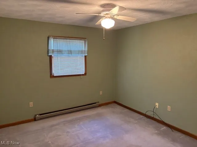 Bedroom featuring baseboard heating and ceiling fan
