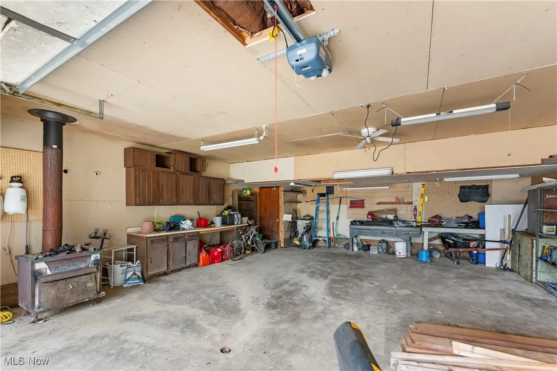 Garage with a workshop area and a garage door opener