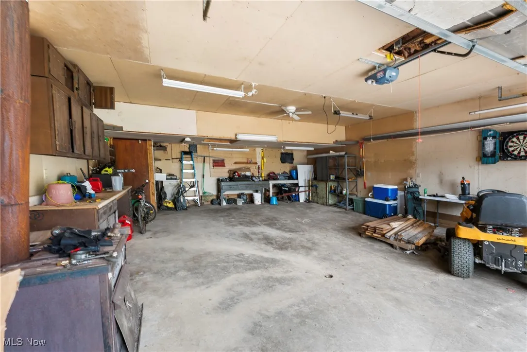 Garage with a workshop area and a garage door opener