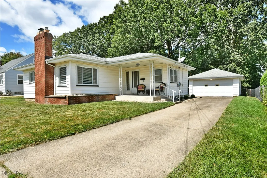 Ranch-style house with covered porch, 2 car garage, decorate brick chimney