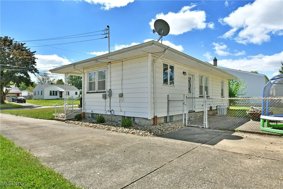 View of home's exterior with a gate and a central air condition unit