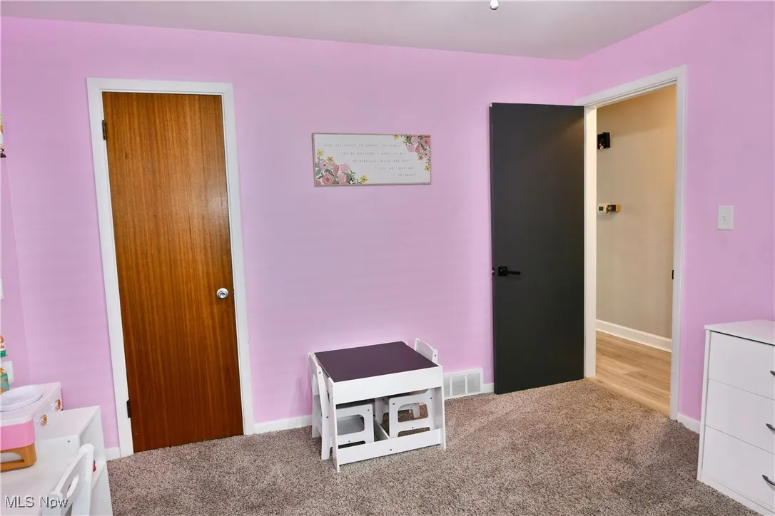 Bedroom featuring carpet flooring and baseboards