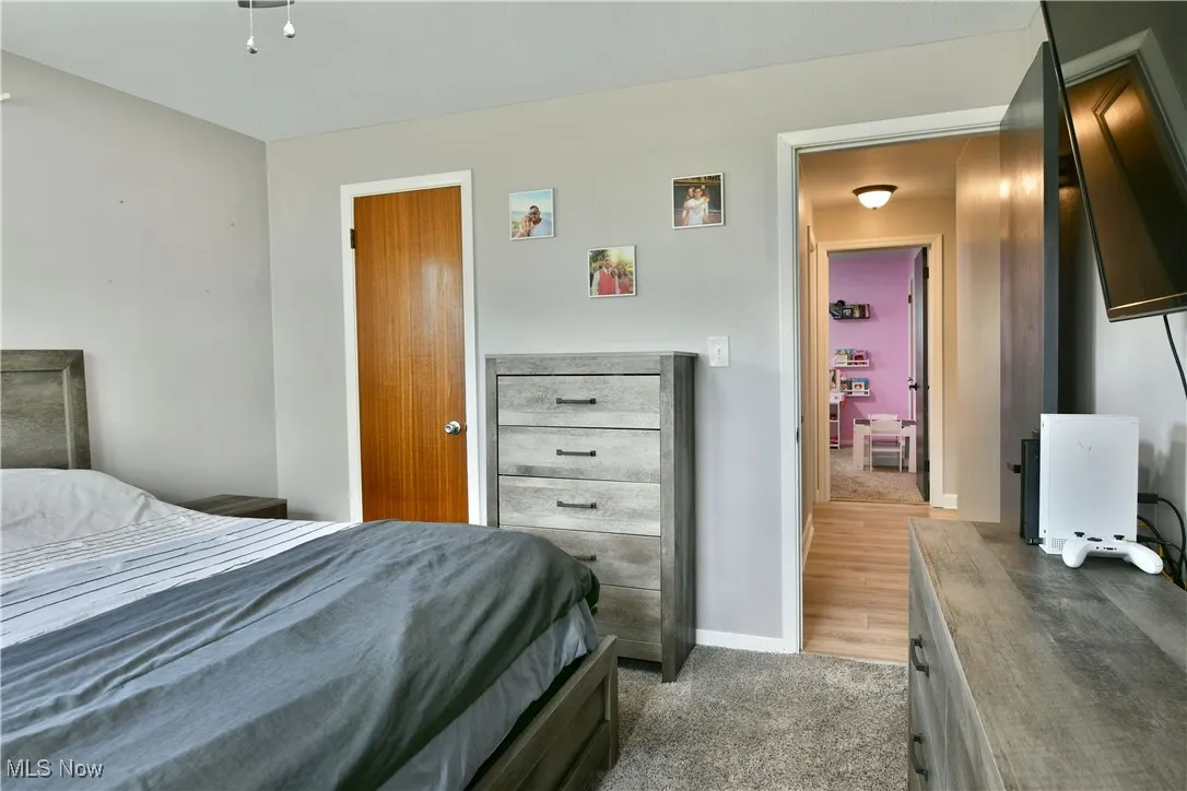 Bedroom featuring baseboards and light colored carpet