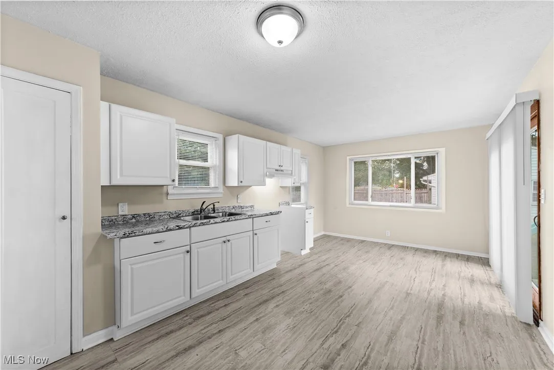 View of the brand new kitchen with new flooring, new cabinets, new counter tops and freshly painted.