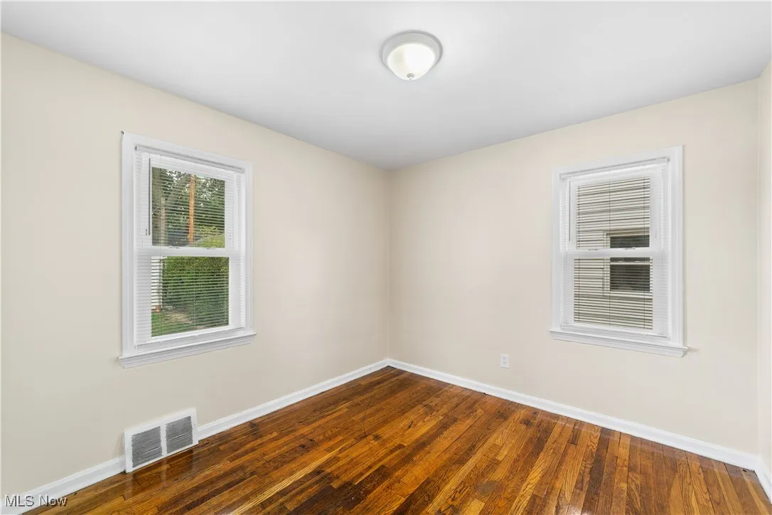 View of bedroom 2 in the home with hardwood flooring.