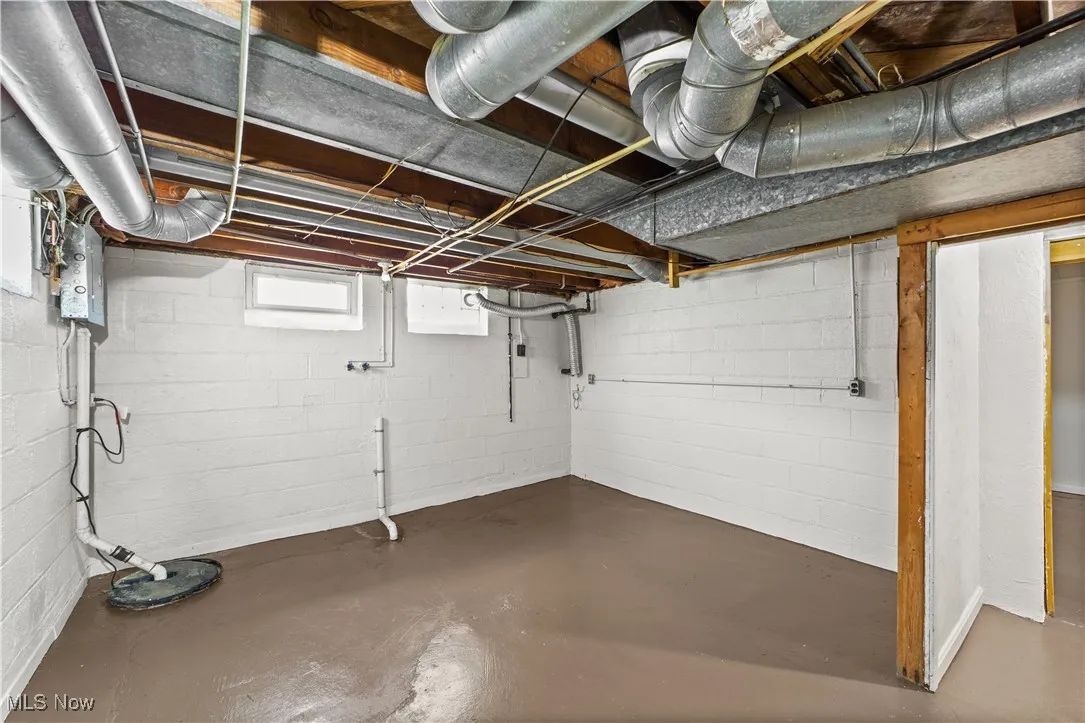 Another portion of the basement with sump pump