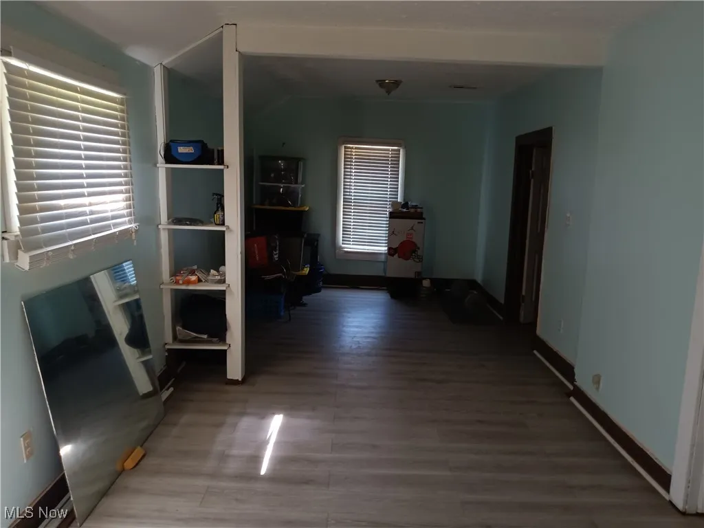 Hallway featuring baseboards and light wood-style floors