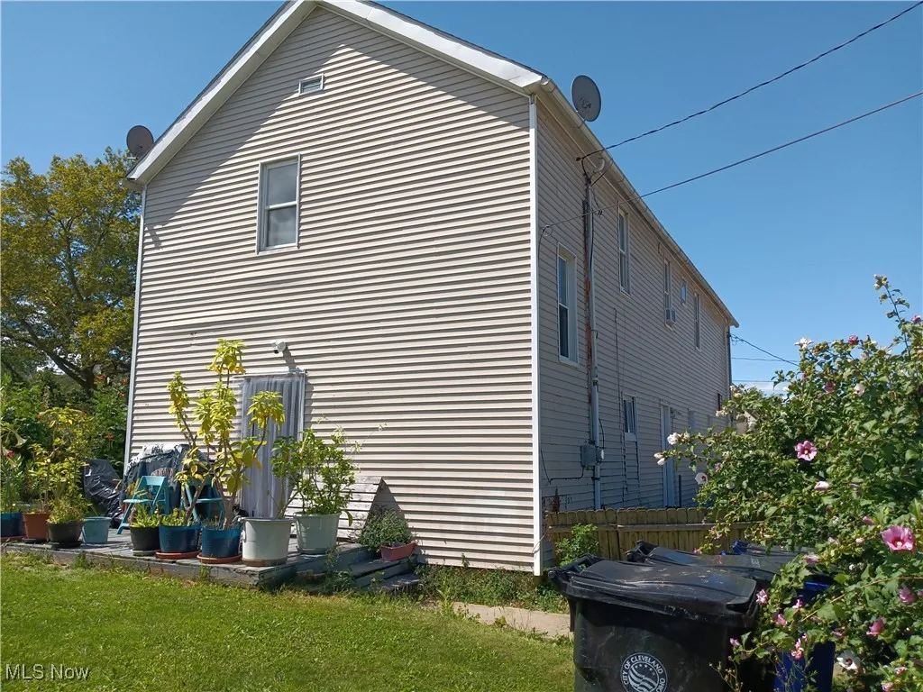 View of side of property with a lawn