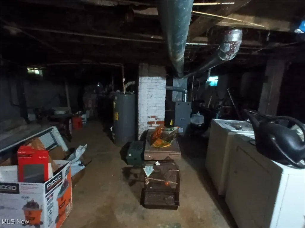 Unfinished basement featuring water heater and heating unit