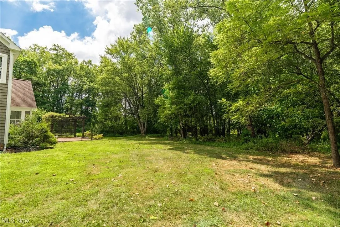 Lush lot and five acres of privacy- yet close to everything!