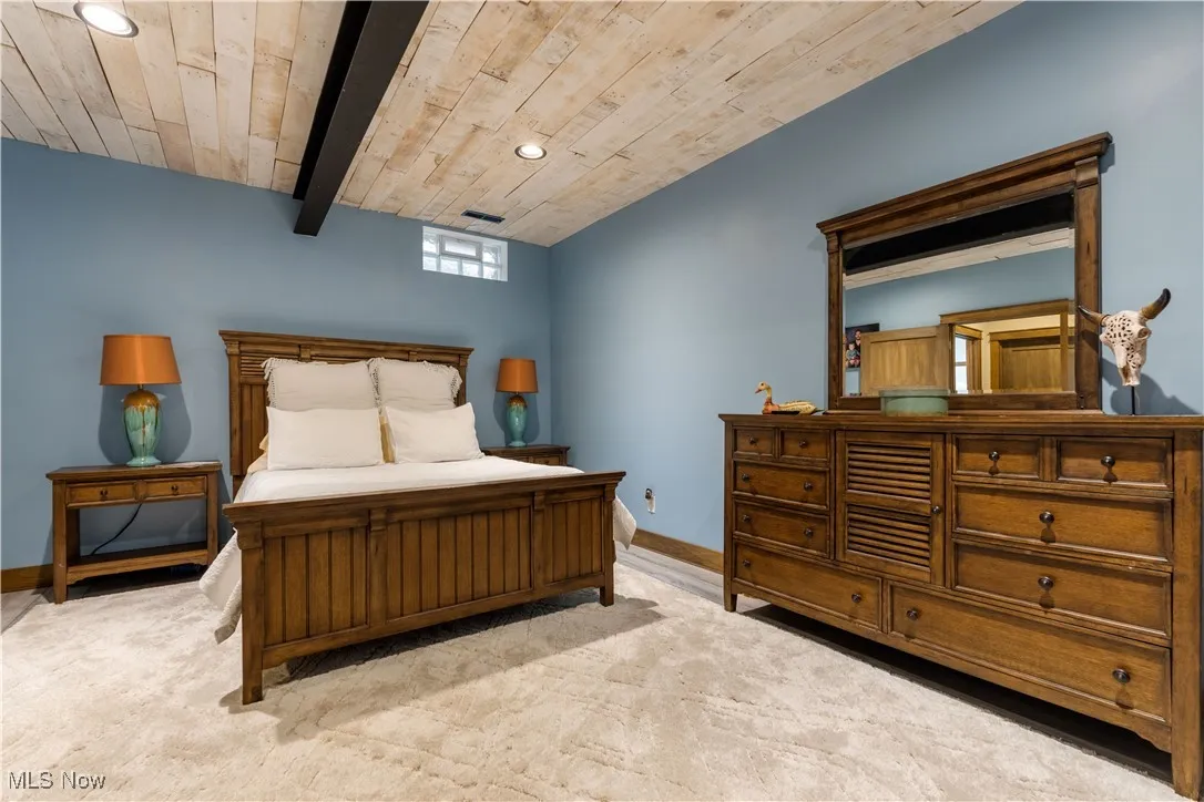 Optional 5th bedroom in the lower level with a beamed ceiling.