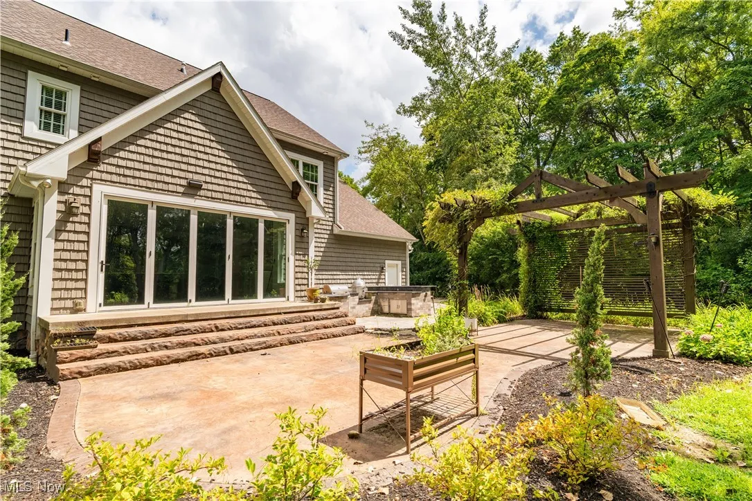 The back patio has an outdoor built in grill and doors that open all the way across.
