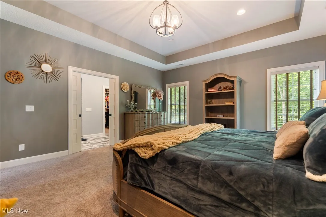 The master suite has large windows and a generous walk-in closet.