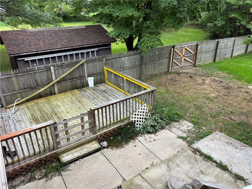 Deck with a fenced backyard - two storage sheds also - privacy fencing with a gate