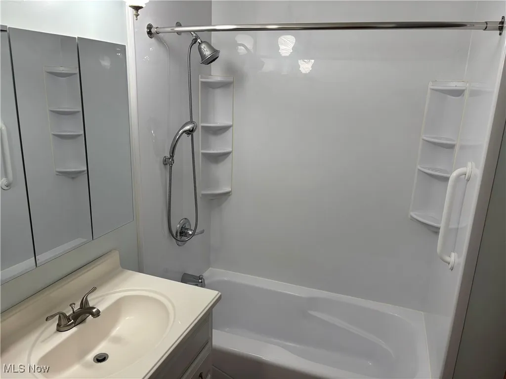Full bathroom featuring shower / bath combination and vanity