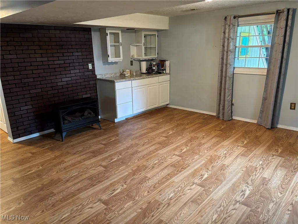 Lower level finished family room with an electric fireplace and storage- more storage under the stairs, and another coat closet.