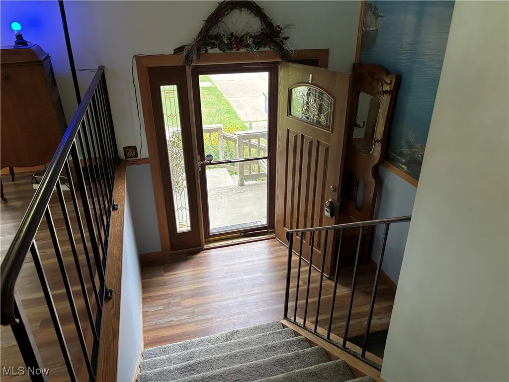 Entrance foyer with wood finished floors