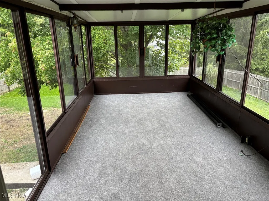3 season sunroom with brand new carpet and wonderful views of your .55 acre lot.