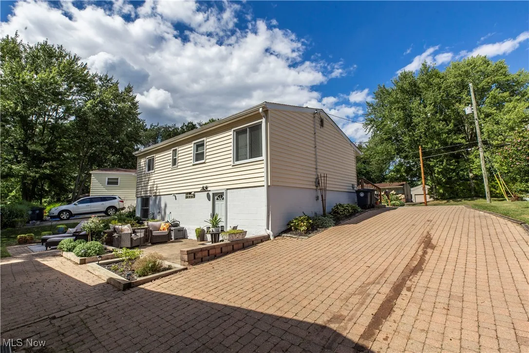 View of side of property featuring an outdoor living space and a patio