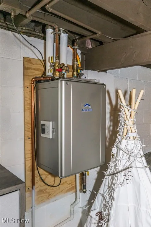 Utility room featuring water heater