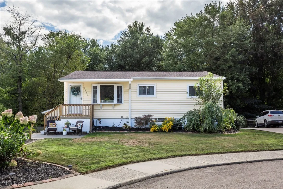 View of front of home featuring a front lawn and roof with shingles