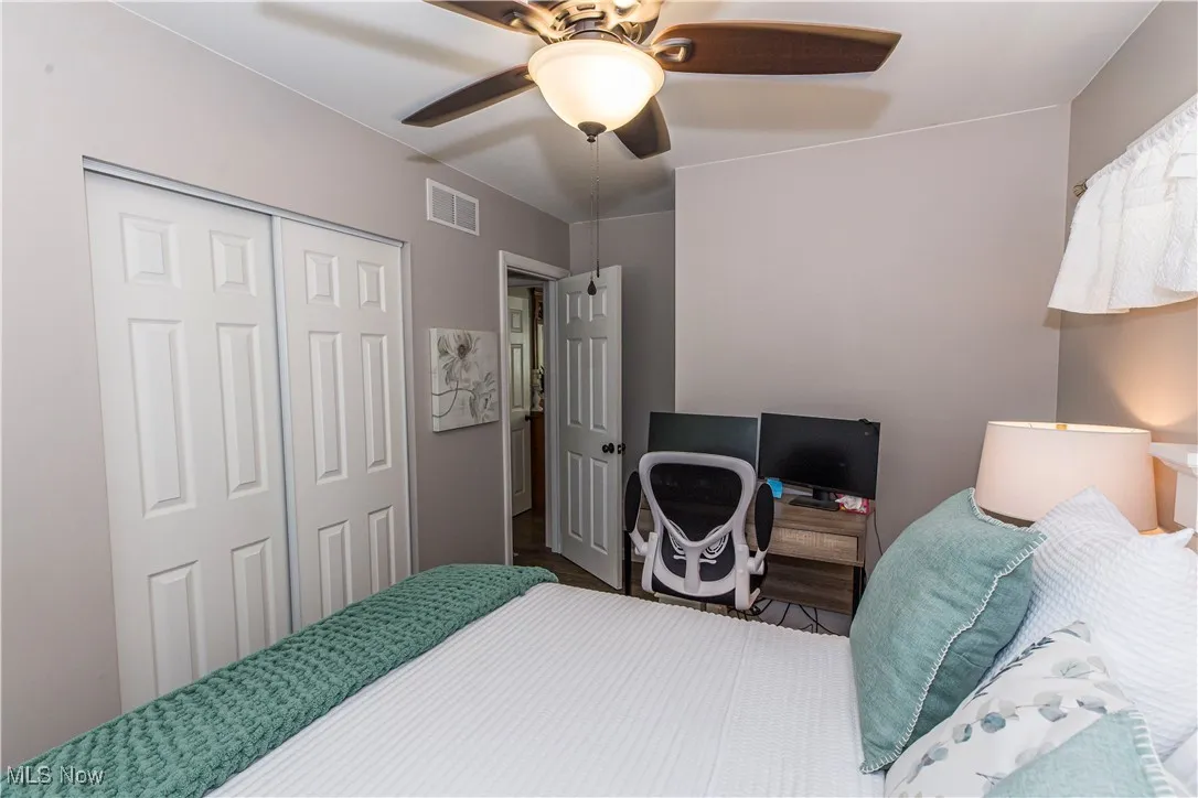 Bedroom with a ceiling fan and a closet