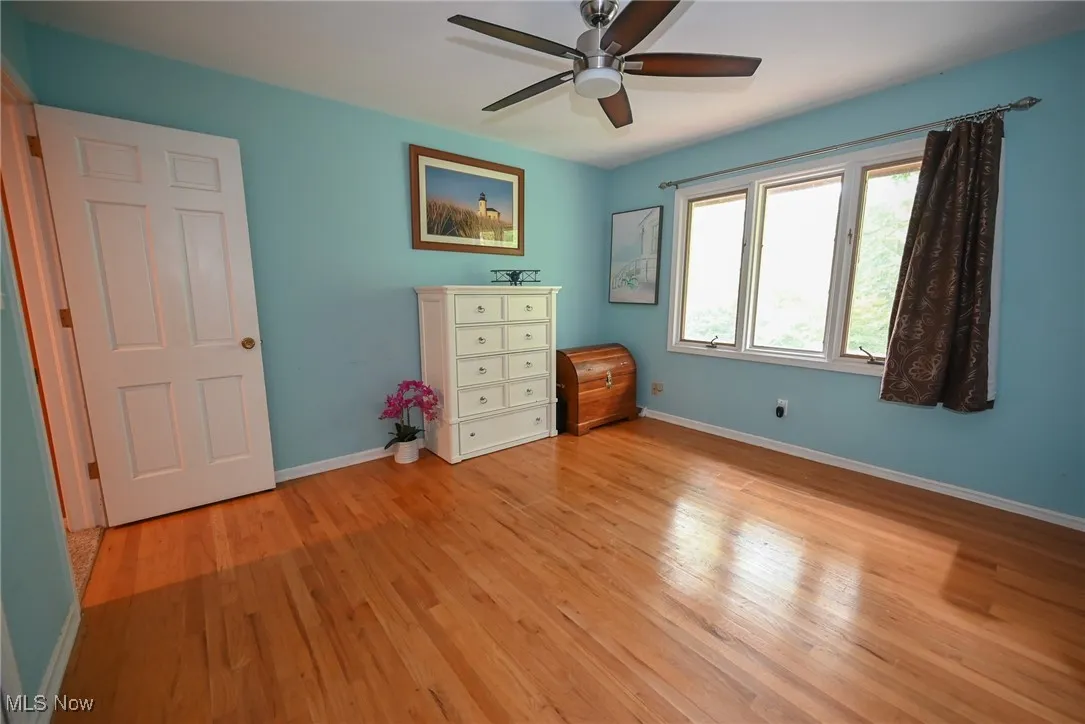 Unfurnished bedroom featuring light wood-style flooring and a ceiling fan
