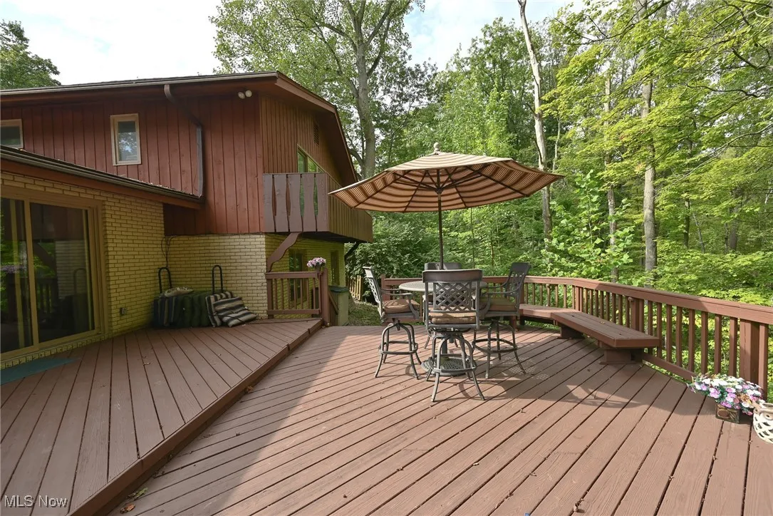Wooden deck featuring outdoor dining space