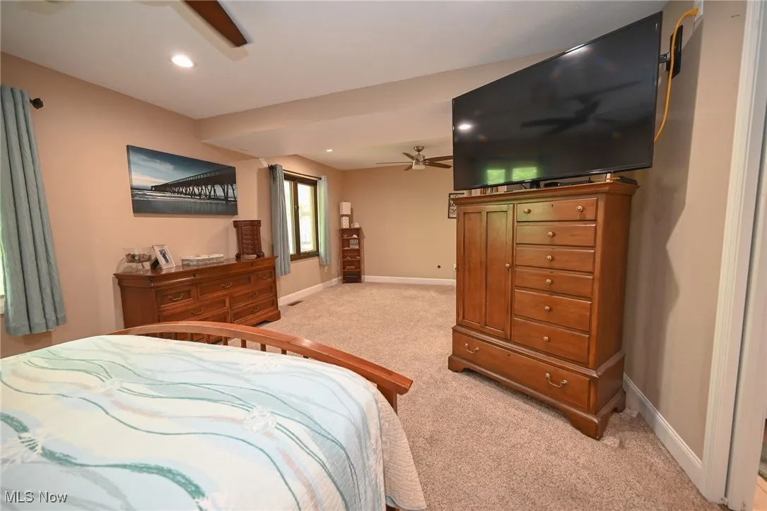 Bedroom with light carpet, recessed lighting, and ceiling fan