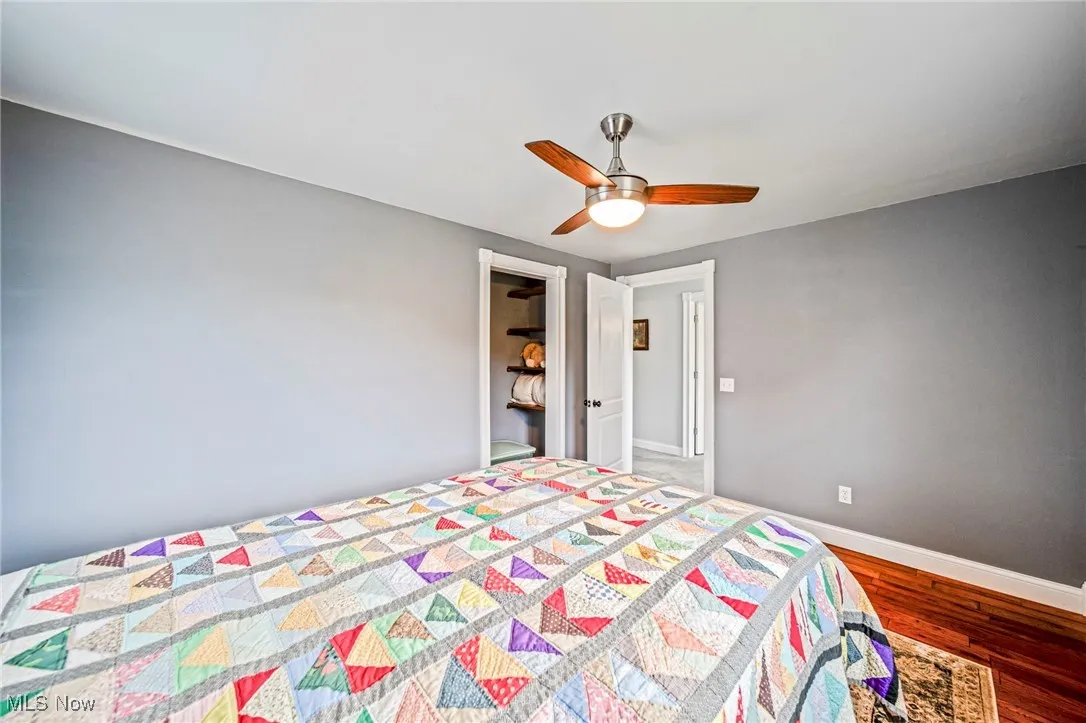 Bedroom with wood finished floors and a ceiling fan