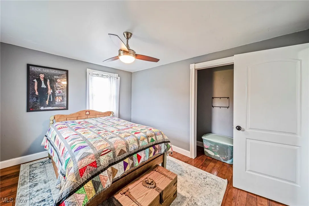 Bedroom with hardwood / wood-style flooring and a ceiling fan
