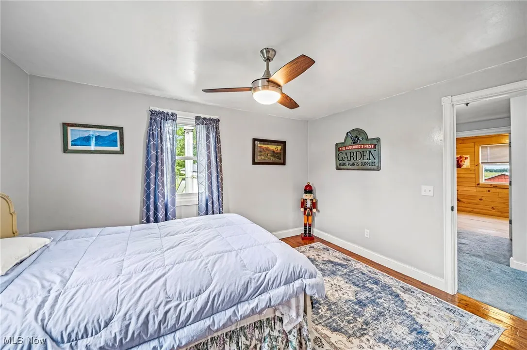 Bedroom featuring wood finished floors and ceiling fan