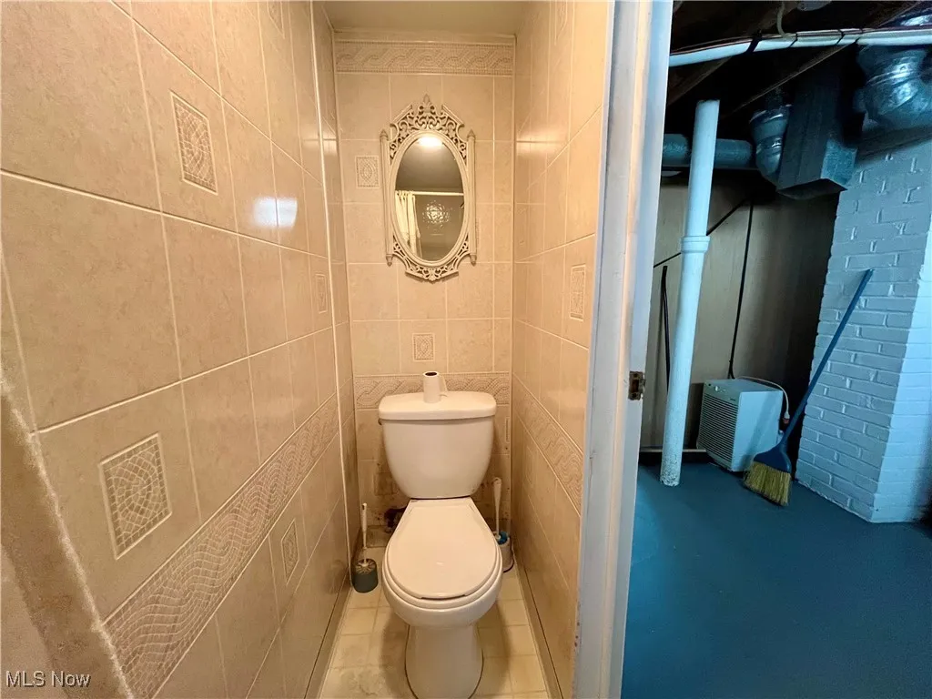 Bathroom featuring tile walls and tile patterned flooring