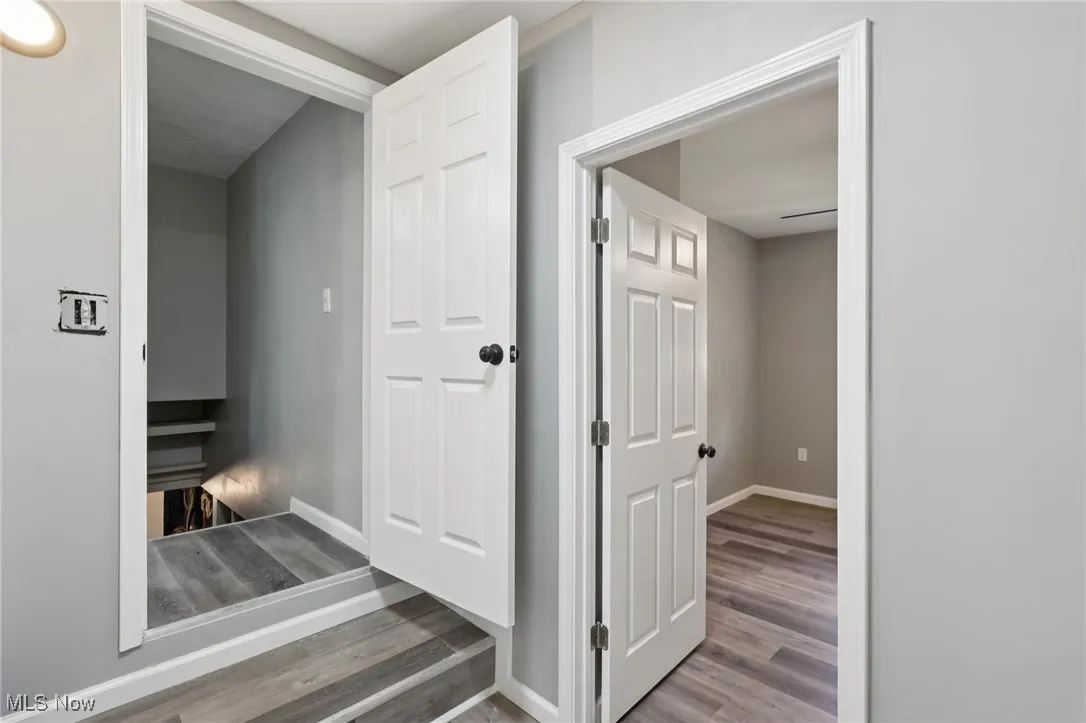Corridor featuring baseboards and wood finished floors