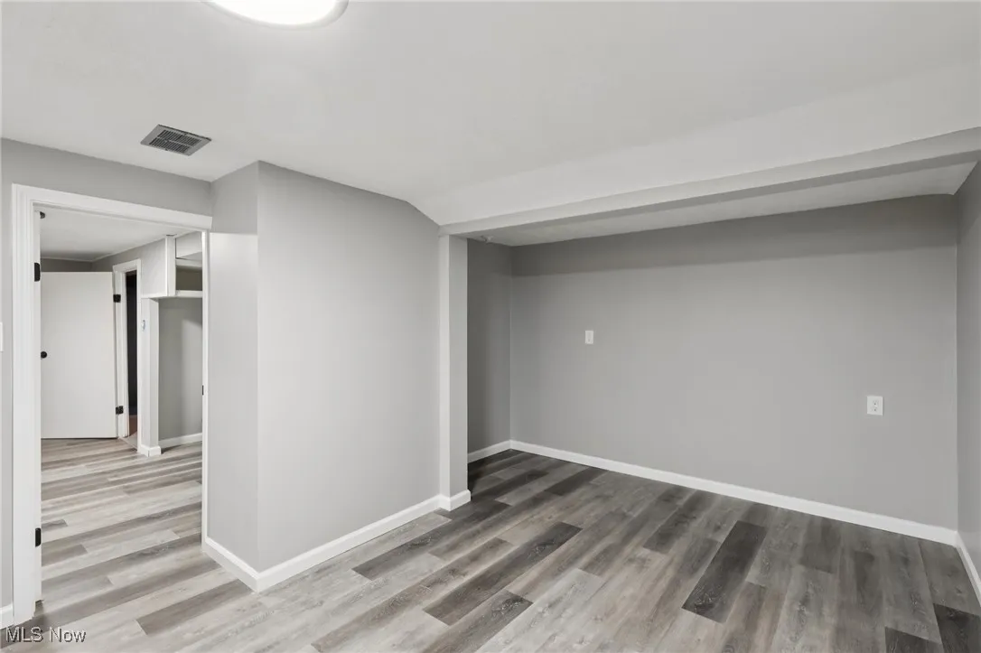 Below grade area featuring light wood-type flooring and baseboards