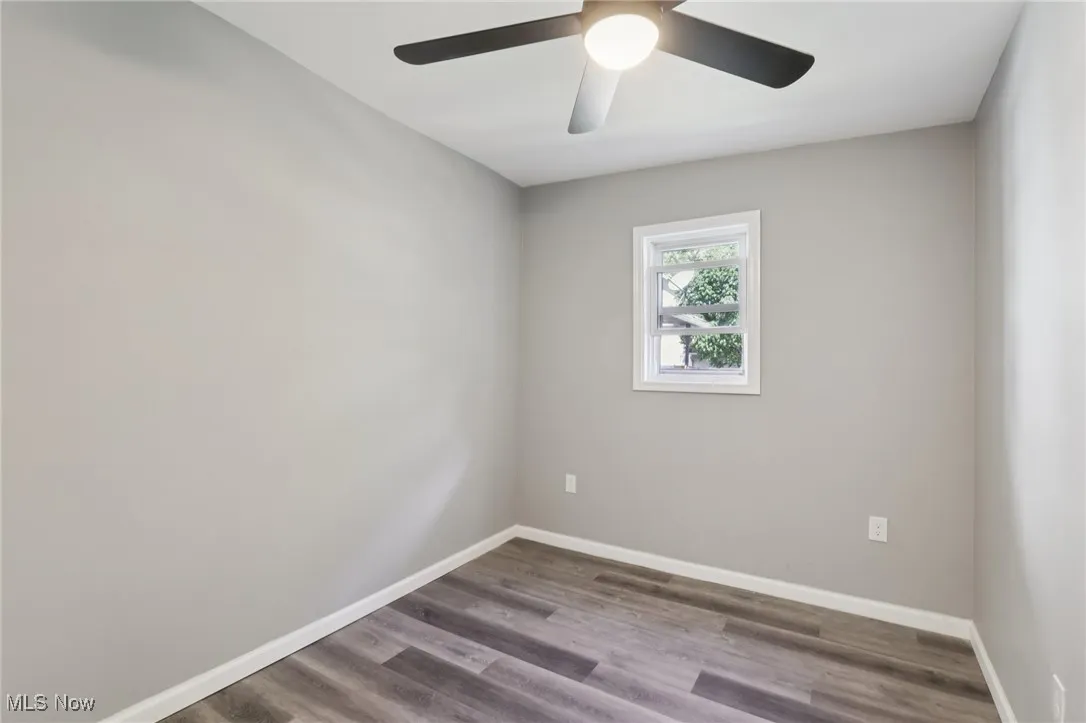 Spare room featuring wood finished floors and a ceiling fan