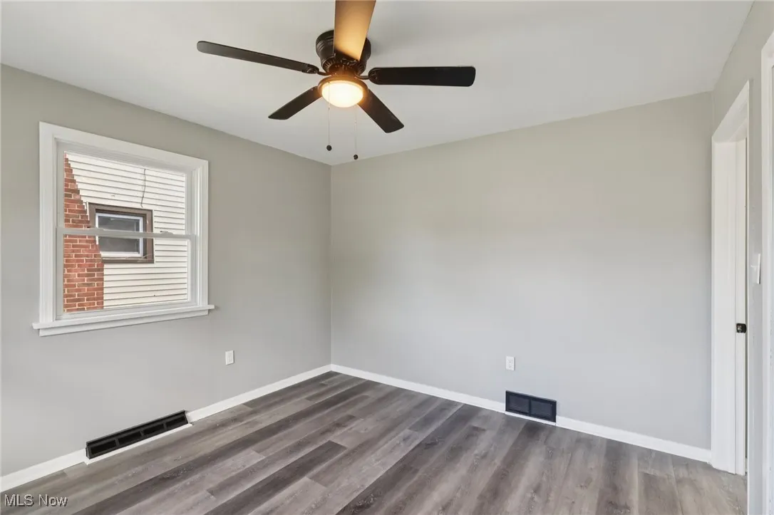 Spare room featuring wood finished floors and ceiling fan