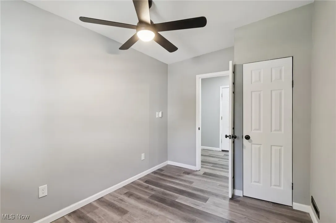 Unfurnished bedroom with wood finished floors and a ceiling fan
