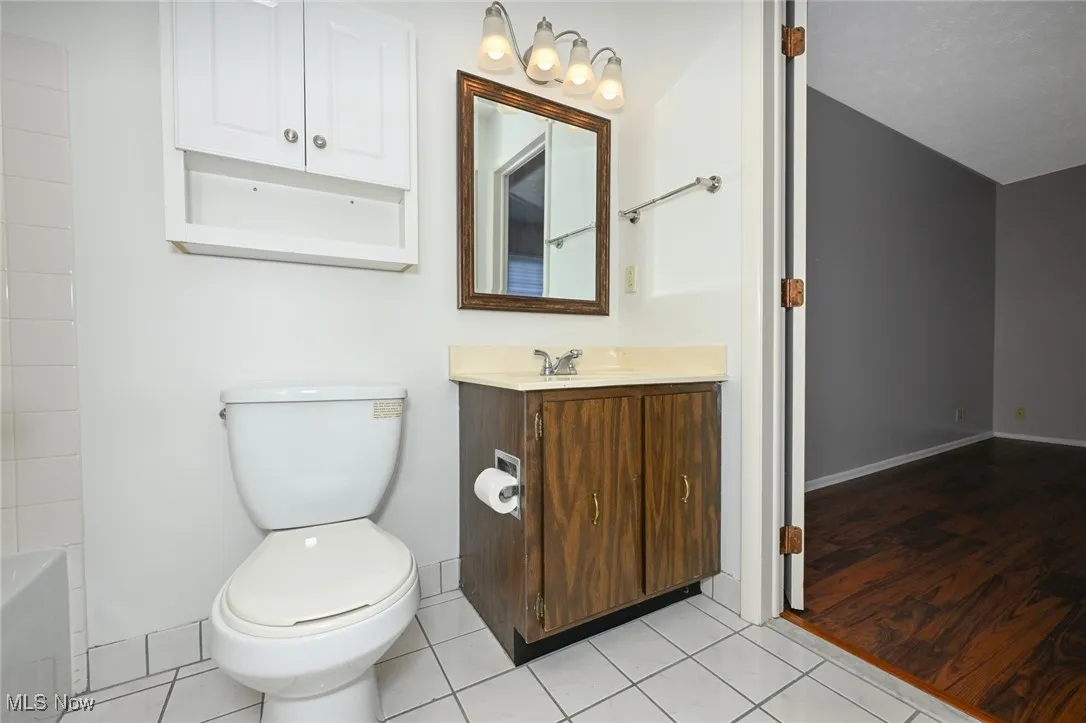 Full bathroom featuring vanity and light tile patterned floors