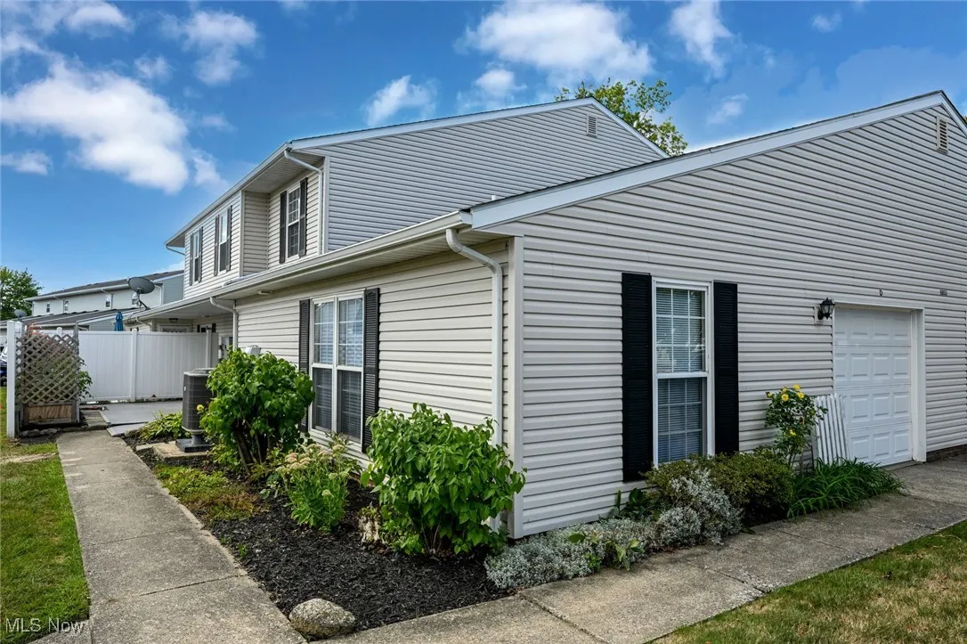 View of side of property featuring an attached garage