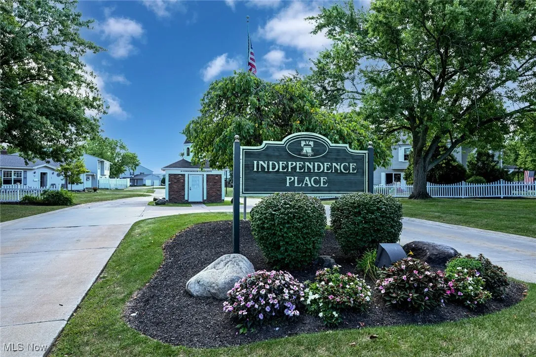 Community / neighborhood sign featuring a residential view