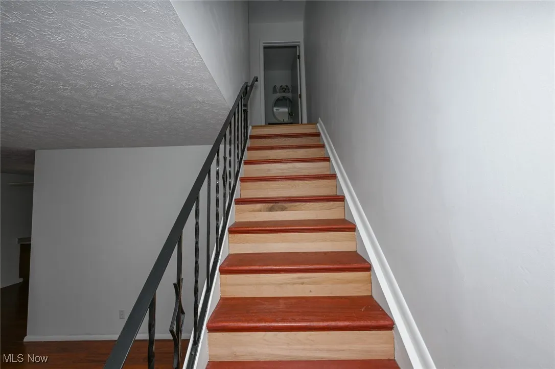 Stairway to second level with two additional bedrooms and full bathroom