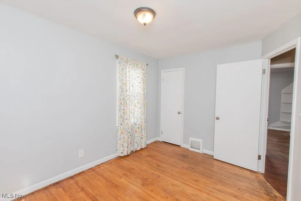 Unfurnished bedroom with a closet and light wood finished floors