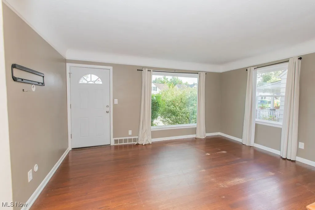 Entrance foyer featuring healthy amount of natural light and dark wood finished floors