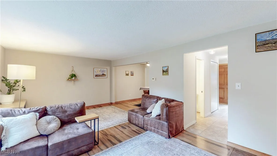 Additional view of Living room from fireplace hearth noting flow to hallway & DR