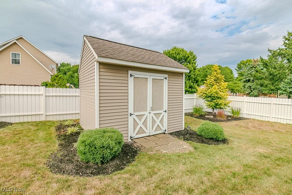 View of shed with a fenced backyard