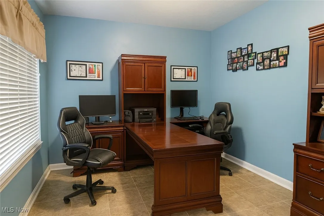 Home office with baseboards and light tile patterned flooring