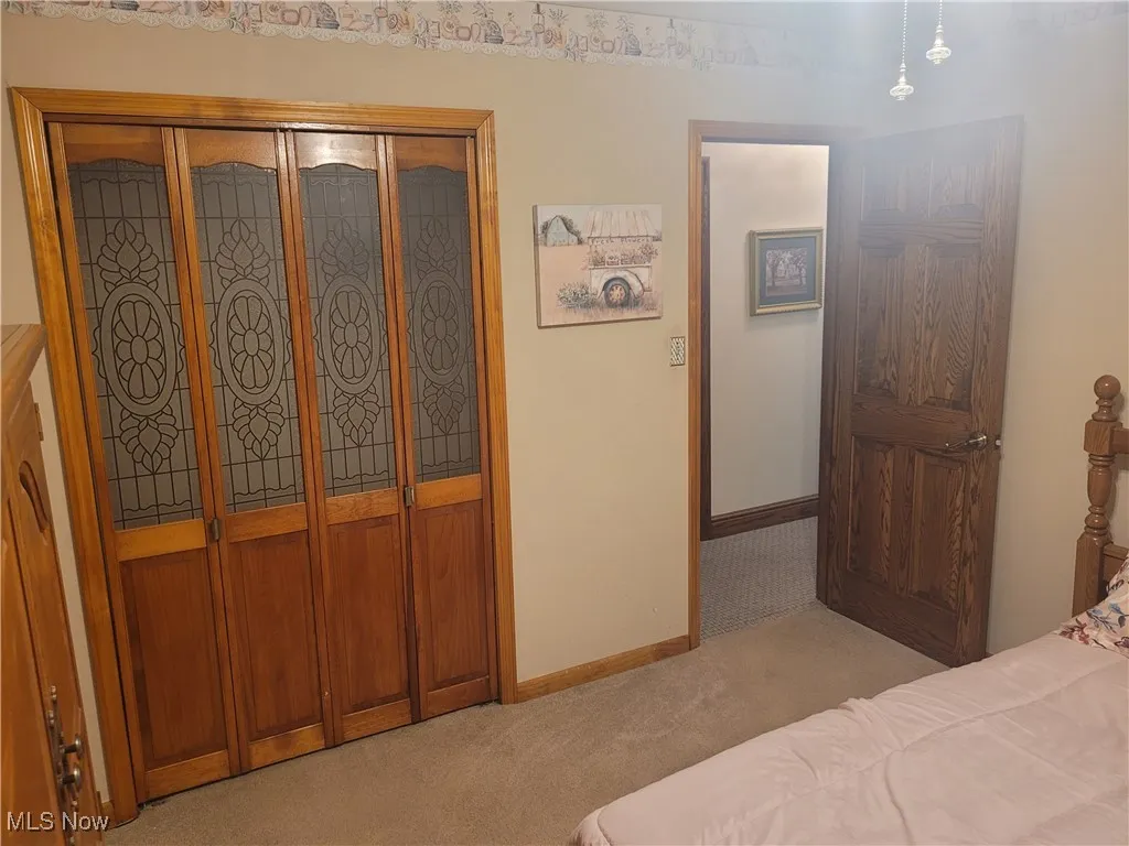 Bedroom featuring a closet and light carpet