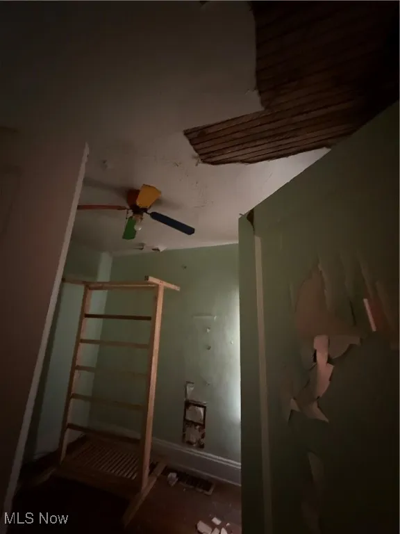 Unfurnished bedroom with ceiling fan and baseboards