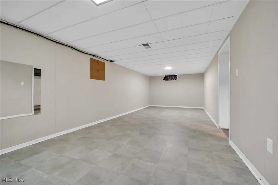 Finished basement featuring light floors and baseboards